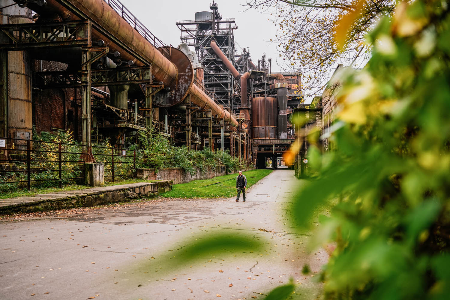 Ein Mann wandert über das industrielle Gelände des Landschaftsparks Duisburg-Nord.