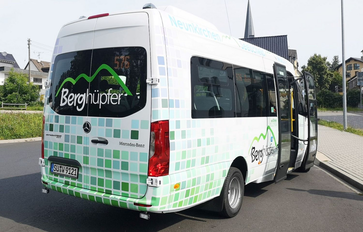 Ein weiß-grüner Kleinbus, auf den der Schriftzug Berghüpfer geklebt wurde.